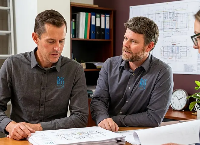 Construction specialist reviewing architectural plans on a tablet